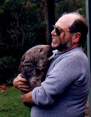 jan howard finder holds a wombat on his trip to Australia